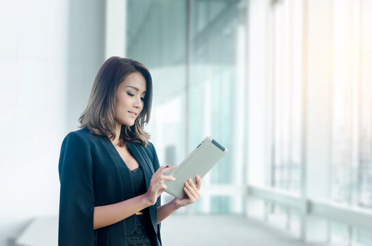 Beautiful Asian Businesswoman Using Tablet In Office