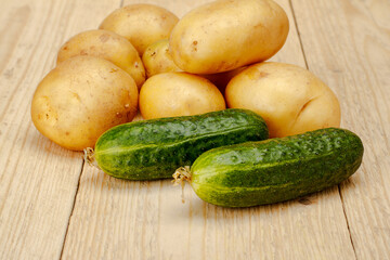 Cucumber potatoes on a white wooden background