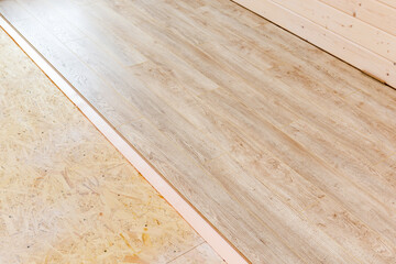 Process of laminate floor installation in the frame house