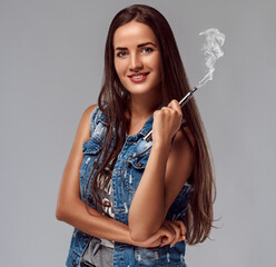 Obraz premium Young woman is smoking e-cigarette. Vape.
