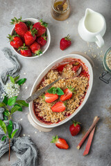 strawberry  and rhubarb oats crumble pie in baking dish