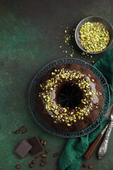 chocolate bundt cake with chocolate glaze and pistachios
