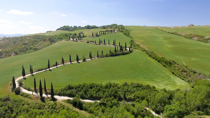 Fototapeta na wymiar Amazing aerial view of Tuscany countryside winding road in spring season - Italy