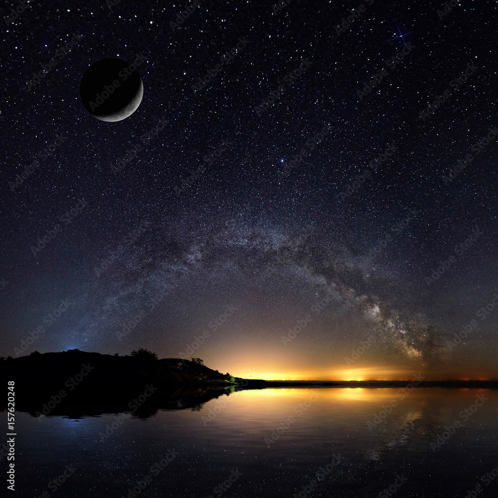 Wall mural amazing panoramic landscape view of a milky way. milky way over the lake.