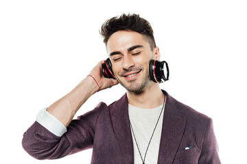Naklejka premium Cheerful young man with closed eyes listening music in headphones