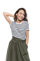 Smiling young woman with hand in pocket of skirt posing and looking away