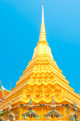 Fototapeta premium Giants under golden pagoda, Warrior statue at The Grand Palace and the temple Wat Phra Kaeo. Bangkok. Thailand.