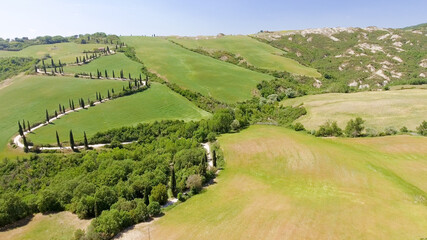Fototapeta premium Amazing aerial view of Tuscany countryside winding road in spring season - Italy