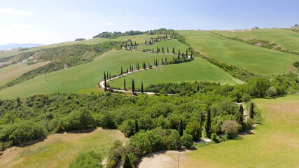 Amazing aerial view of Tuscany countryside winding road in spring season - Italy