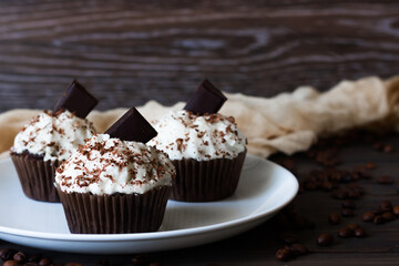Chocolate-coffee cupcakes on a dark wooden background
