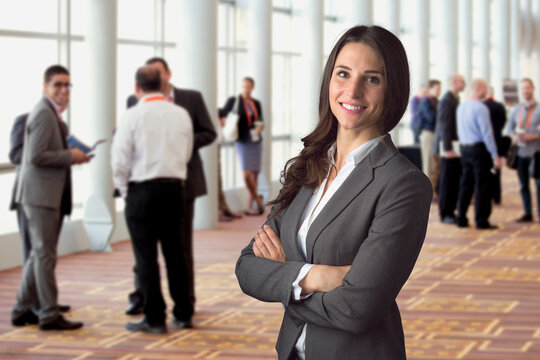 Happy business woman standing in crowd at workshop event with big genuine natural smile