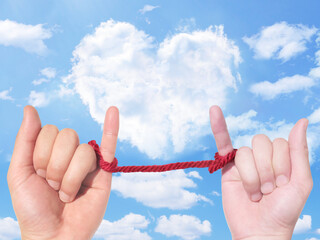 couple hand red string heart cloud background