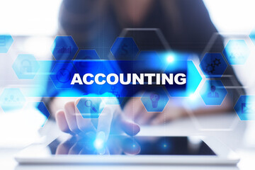 Woman using tablet pc, pressing on virtual screen and selecting accounting.