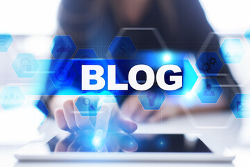 Woman using tablet pc, pressing on virtual screen and selecting blog.