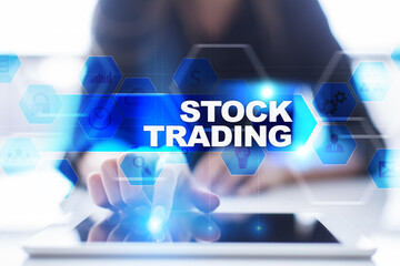 Woman using tablet pc, pressing on virtual screen and selecting stock trading.