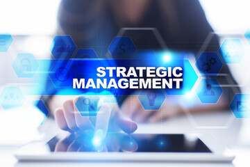 Woman using tablet pc, pressing on virtual screen and selecting strategic management.