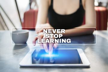 Woman using tablet pc and selecting never stop learning.