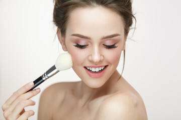 Facial Makeup. Beautiful Female Applying Blush With Brush