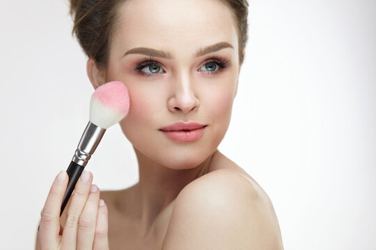 Facial Beauty Cosmetics. Sexy Woman Applying Blush With Brush
