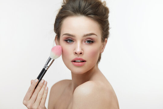 Facial Beauty Cosmetics. Sexy Woman Applying Blush With Brush