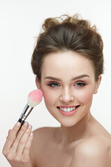 Woman Beauty Make-Up. Happy Woman Applying Pink Blush On Skin