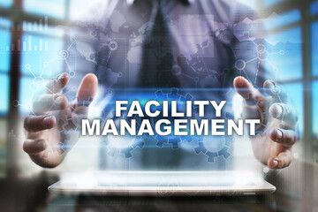 Fototapeta na wymiar Businessman using tablet pc and selecting facility management.