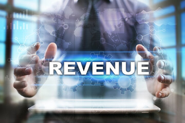 Fototapeta na wymiar Businessman using tablet pc and selecting revenue.