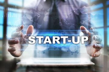 Fototapeta na wymiar Businessman using tablet pc and selecting start-up.