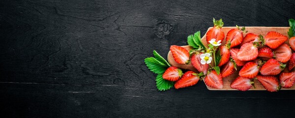 Fresh strawberries. Healthy food. On Wooden background. Top view. Free space.