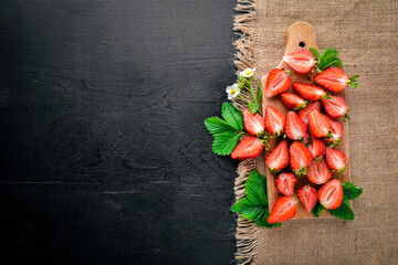 Fresh strawberries. Healthy food. On Wooden background. Top view. Free space.