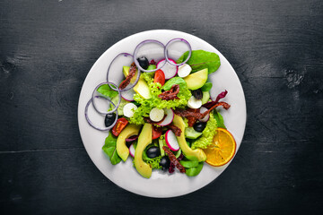 Avocado Salad with grilled meat and greens. Italian cuisine. Top view. On Wooden background.