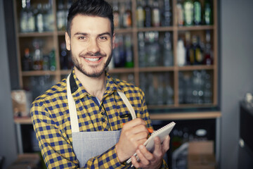 Bartdender writing down an order