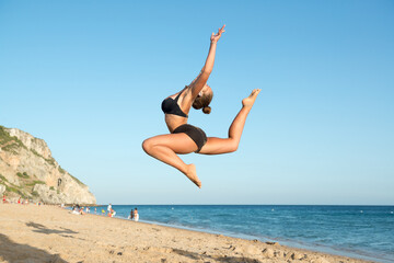 Girl jumping in the beach