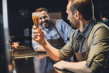 Brewery worker with glass of beer