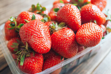 fresh red strawberry lying on wooden background