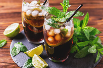 Cuba Libre cocktail with cola, lime, rum and peppermint