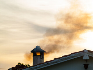 Smoke on a chimney at an ancient rural house