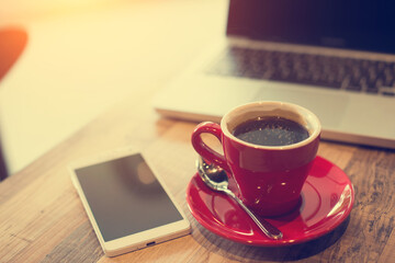 laptop and black coffe in vintage tone