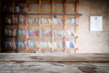 Selected focus empty old wooden table and .Library or Bookstore blur background with bokeh image. for your photomontage or product display