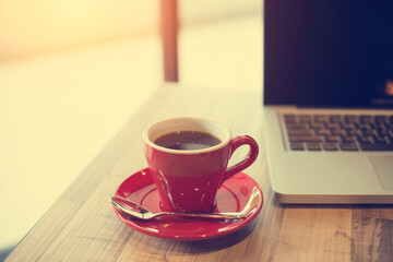 laptop and black coffe in vintage tone