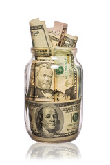 Many dollars in a glass jar isolated on white