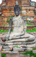 Fototapeta premium AYUTTHAYA, THAILAND - August, 2016: Stone statue of a Buddha in Ayutthaya, Thailand