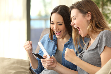 Excited friends checking content on line