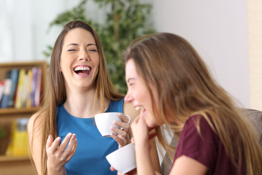 Two Friends Laughing Loud At Home