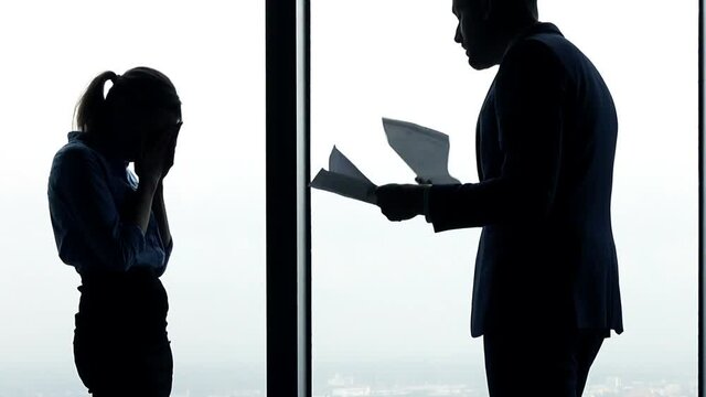  Young businesswoman getting rebuke from boss in the office
