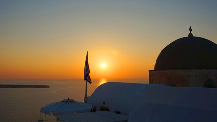 Photo of iconic sunset in Santorini volcanic island, Cyclades, Greece