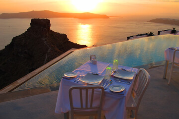 Photo of iconic sunset in Santorini volcanic island, Cyclades, Greece