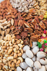 Abundance of a variety of nuts. Cashew, pistachios, marmalade, walnuts, pecans - a healthy food rich in proteins.