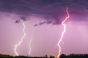 Fototapeta na wymiar Lightning bolt on the dark cloudy sky