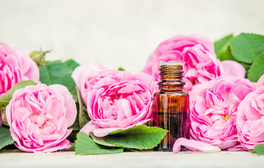 Essential oil of rose on a light background. Selective focus. 